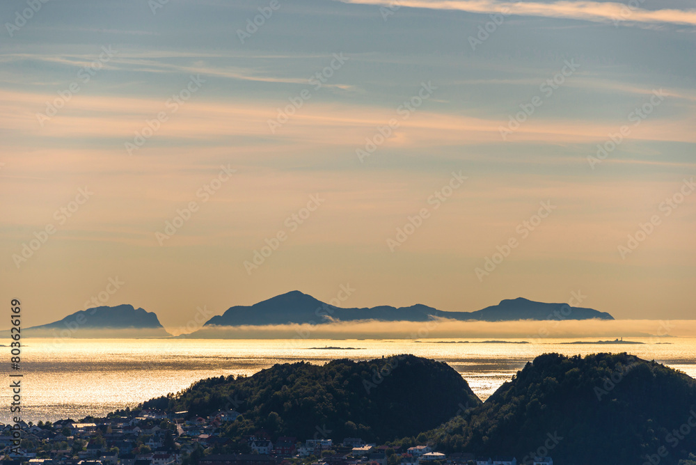 Fototapeta premium top view of a sunset over The city of Alesund and the sea during a sunny evening, Norway