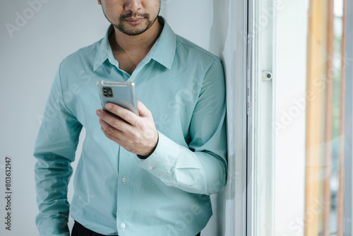 Businessman Using smartphone for communicate with client and colleague about business financial and marketing