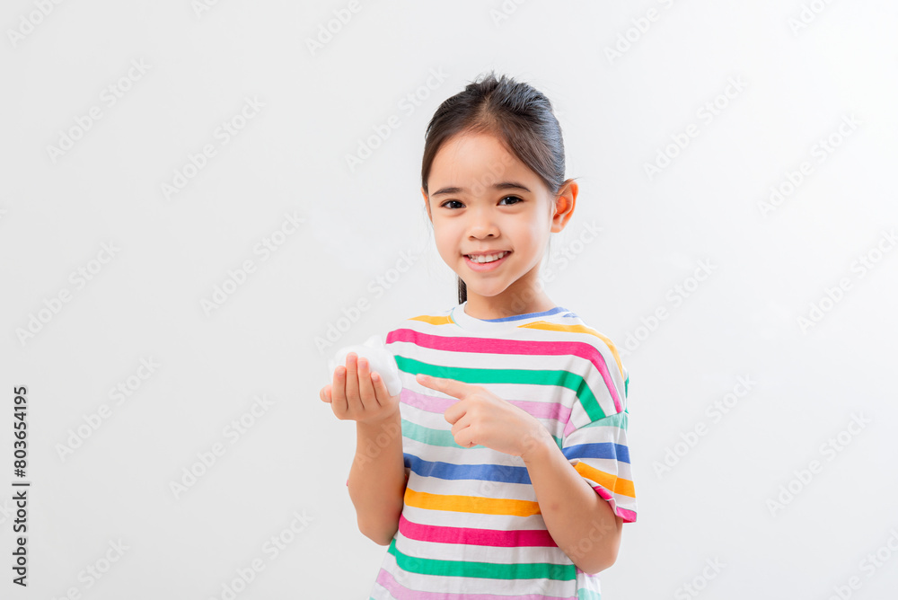 Cute Asian girl, holding foam, washing her face Cute Asian girl, holding foam, washing her face