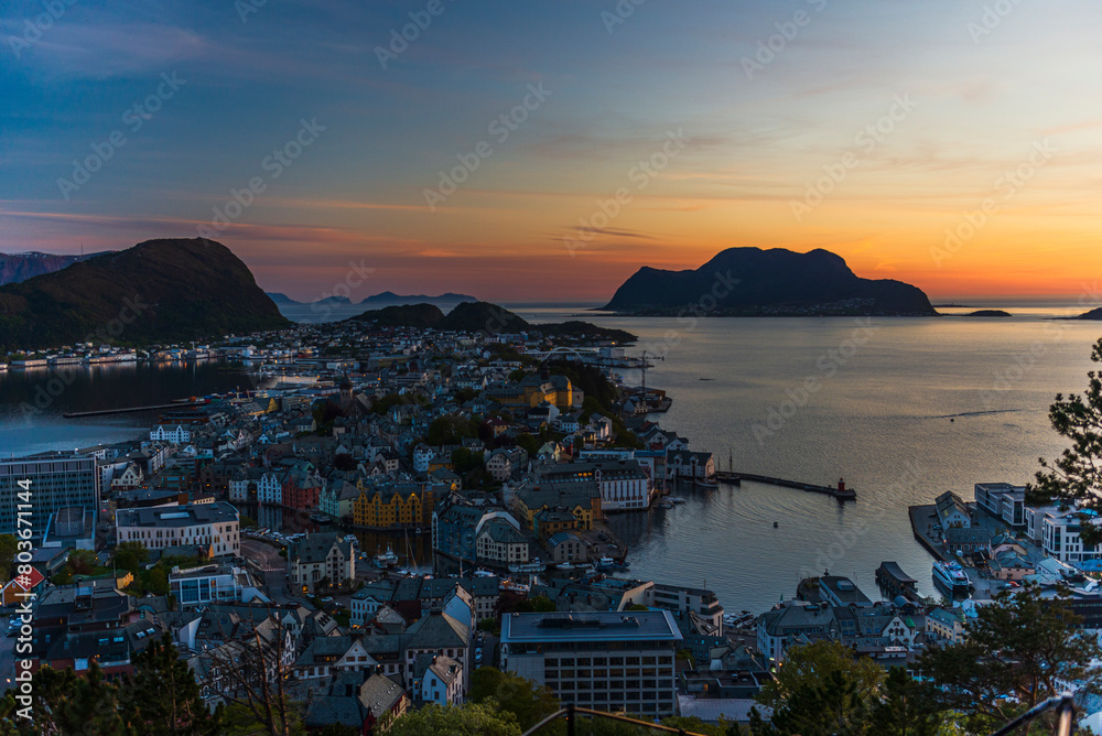 Fototapeta premium top view of a sunset over The city of Alesund and the sea during a sunny evening, Norway