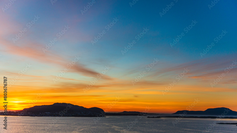 Obraz premium top view of a sunset over The city of Alesund and the sea during a sunny evening, Norway