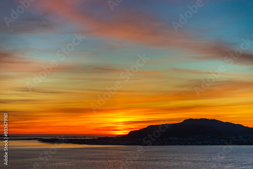 top view of a sunset over The city of Alesund and the sea during a sunny evening, Norway