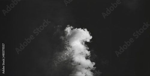 Wispy white smoke cloud rising up on a black background