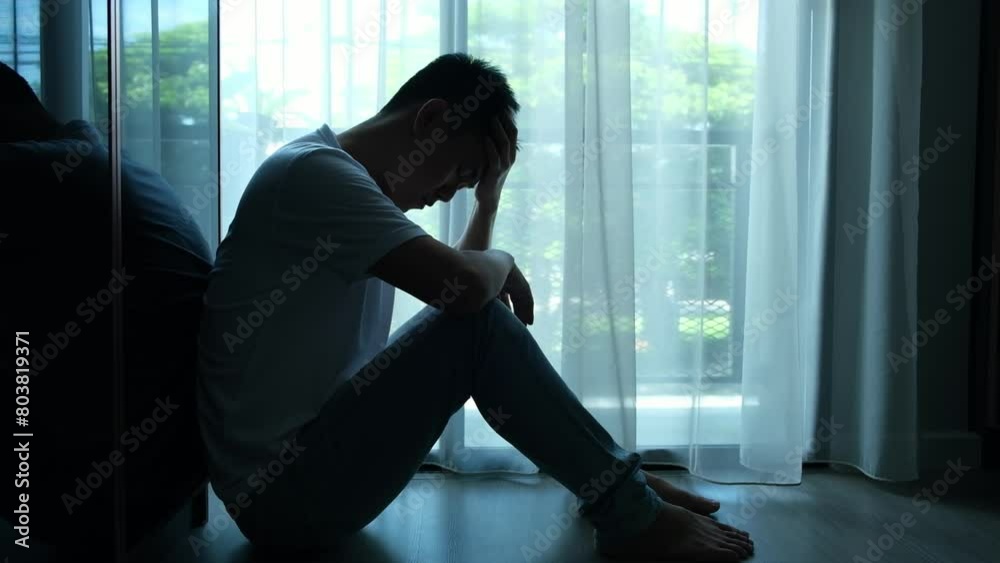 man sitting in the corner of the room have emotional and mental problems He has depression and stress from society and work. medical concept.	