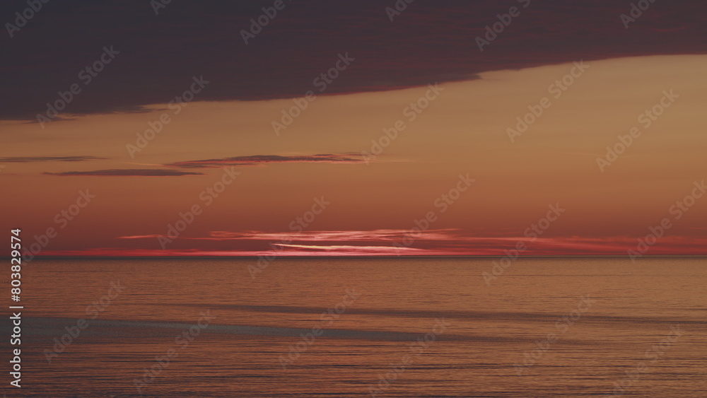 Yellow And Orange Sea At Sunset. Golden Texture Water Surface Small Waves. Sunset Reflections On Sea Surface.
