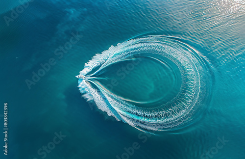 erial view of a speedboat creating a circular water trail in a blue sea, taken from a top down drone photo. The photography shows high resolution and insanely detailed imagery in a hyper realistic sty photo