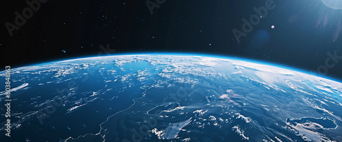 Realistic planet Earth with a blue atmosphere and dark space in the background. The scene is taken from orbit, showcasing an expansive view of our home world against the black sky. A high-resolution p