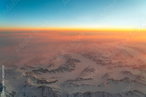Aerial view of snow mountain and frozen river in colorful morning sunlight in Alaska © nd700