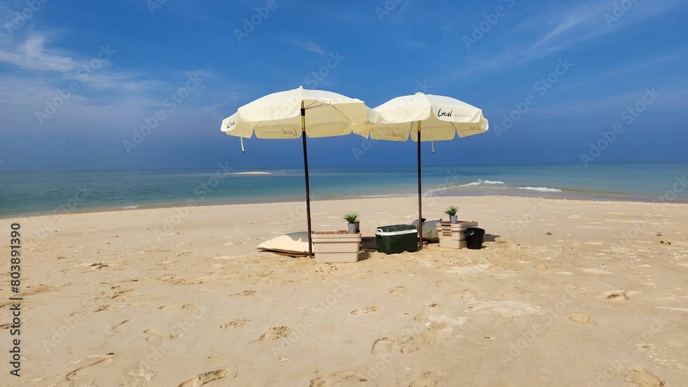 photo of crashing waves on the shoreline, umbrella and chairs on the beach