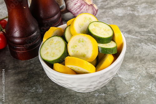 Sliced raw young green and yellow zucchini