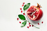 Pomegranate with water drops and leaves isolated on a white background. Exotic fruit