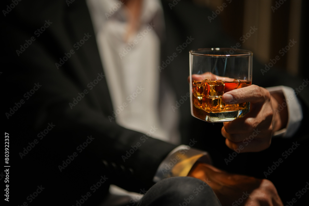 Closeup businessmen holding a glass of whiskey