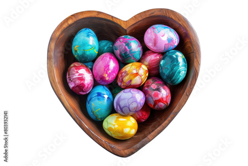 Colored eggs in heart shape wooden bowl isolated on transparent background