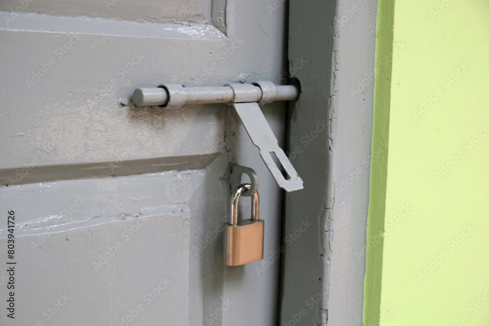old metal lock on the wooden door. old metal lock on the wooden door.