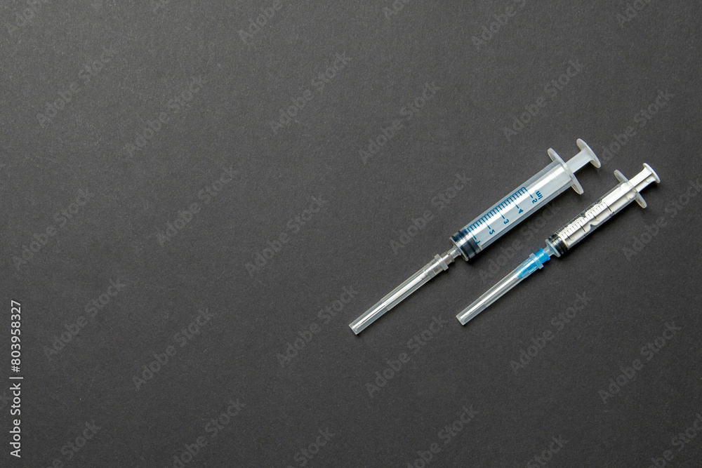 Top view of syringes in a row for medical injection on colorful background with copy space. Health and vaccination concept Top view of syringes in a row for medical injection on colorful background with copy space. Health and vaccination concept