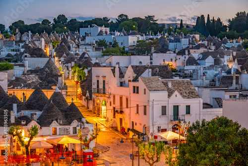 Trulli of Alberobello, Puglia, Italy. town of Alberobello with trulli houses among green plants and flowers