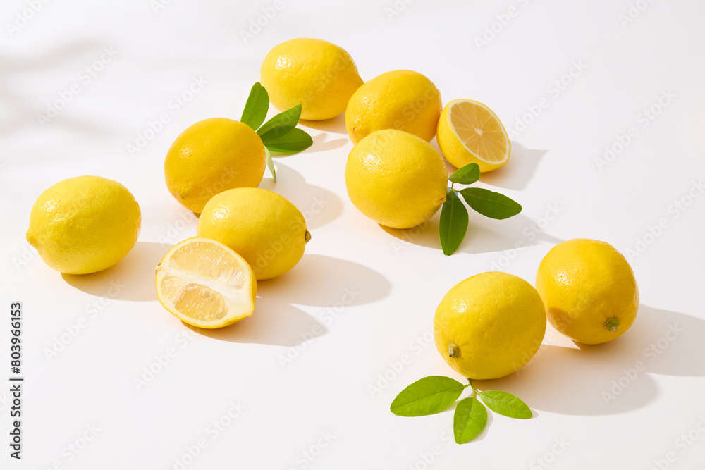 Several fresh yellow lemon flat lay on white counter and the sun shines on it. Advertising template for product of yellow lemon with blank space for text