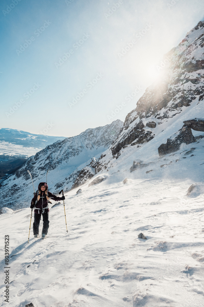 Mountaineer backcountry ski walking ski alpinist in the mountains. Ski touring in alpine landscape with snowy trees. Adventure winter sport. High tatras, Slovakia