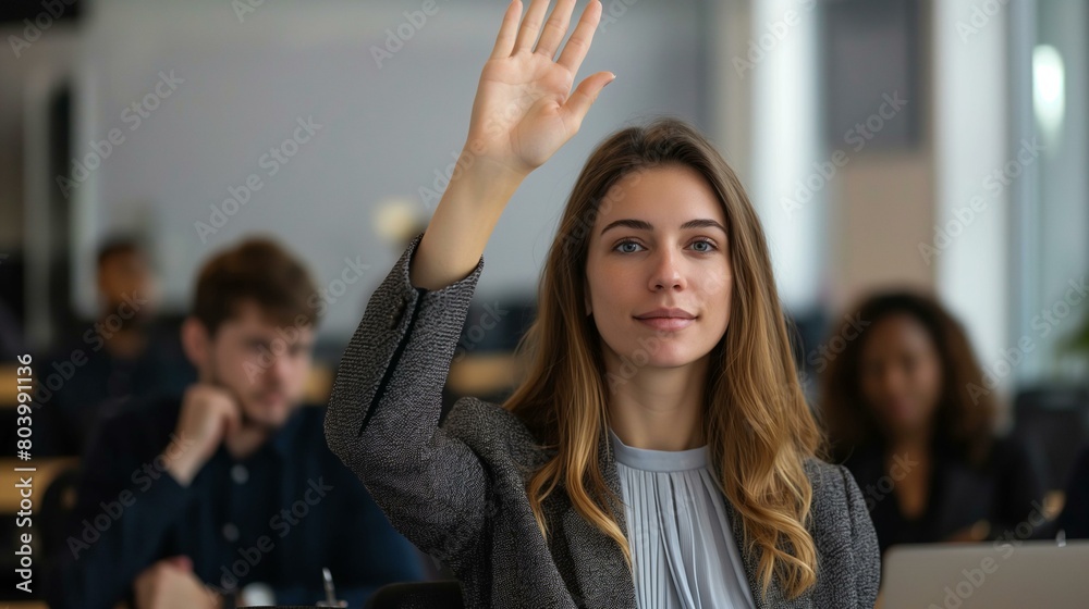 Confident Young Businesswoman Raising Hand in a Meeting Room