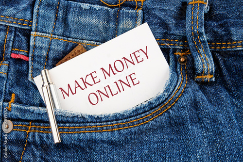 Business concept. MAKE MONEY ONLINE lettering written on a business card peeking out of a jeans pocket