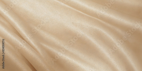 A light colored fabric with a pattern of waves. The fabric is smooth and silky. The waves are small and spaced out