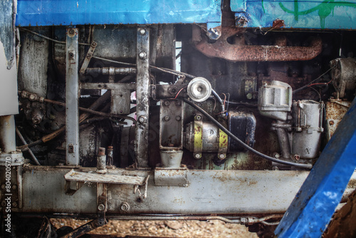 Detail of greasy motor mechanics of an old tractor in need for repair