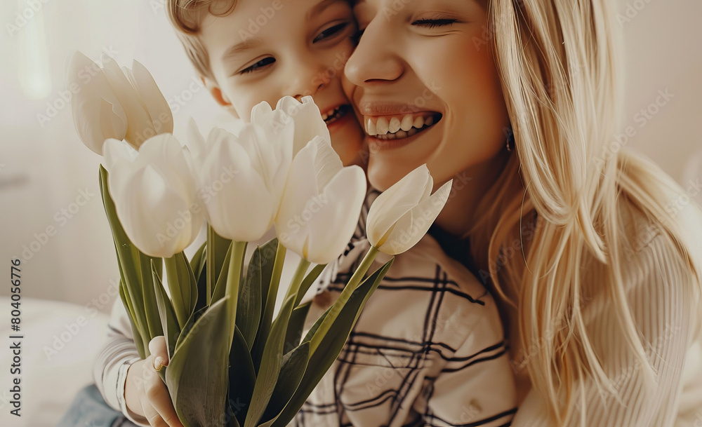 A mother hugging their son on mother's day with a bunch of flowers
