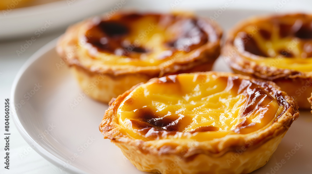 Macro view of a Portuguese custard tart highlighting its texture and caramelized top Macro view of a Portuguese custard tart highlighting its texture and caramelized top