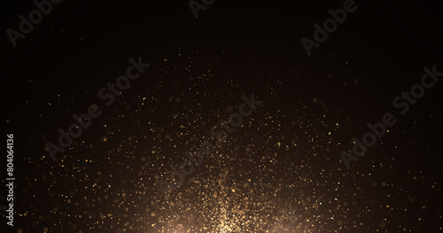 Abstract background of gold particles. Gold shiny background. gold dust and beautiful bokeh on a dark background..