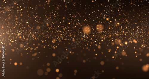 Abstract background of gold particles. Gold shiny background. gold dust and beautiful bokeh on a dark background.. photo