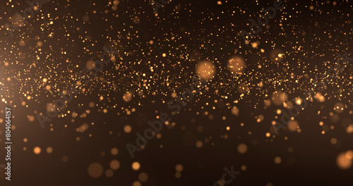 Abstract background of gold particles. Gold shiny background. gold dust and beautiful bokeh on a dark background..