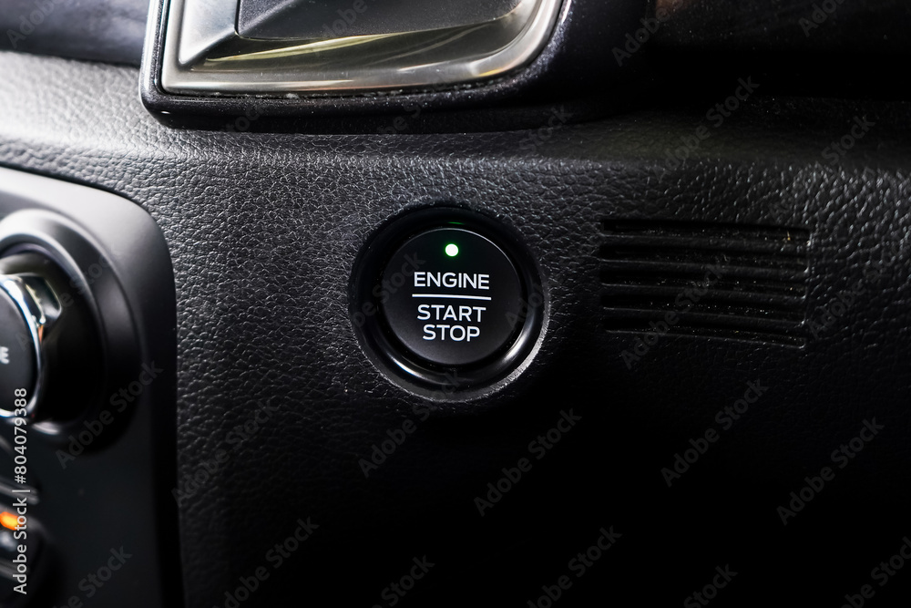 Close up engine car start button. Start stop engine modern new car button,Makes it easy to turn your auto mobile on and off. a key fob unique ,selective focus Close up engine car start button. Start stop engine modern new car button,Makes it easy to turn your auto mobile on and off. a key fob unique ,selective focus