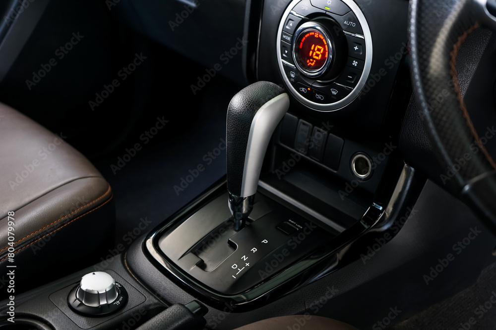automatic transmission shift selector in the car interior. Closeup a manual shift of modern car gear shifter. 4x4 gear shift automatic transmission shift selector in the car interior. Closeup a manual shift of modern car gear shifter. 4x4 gear shift