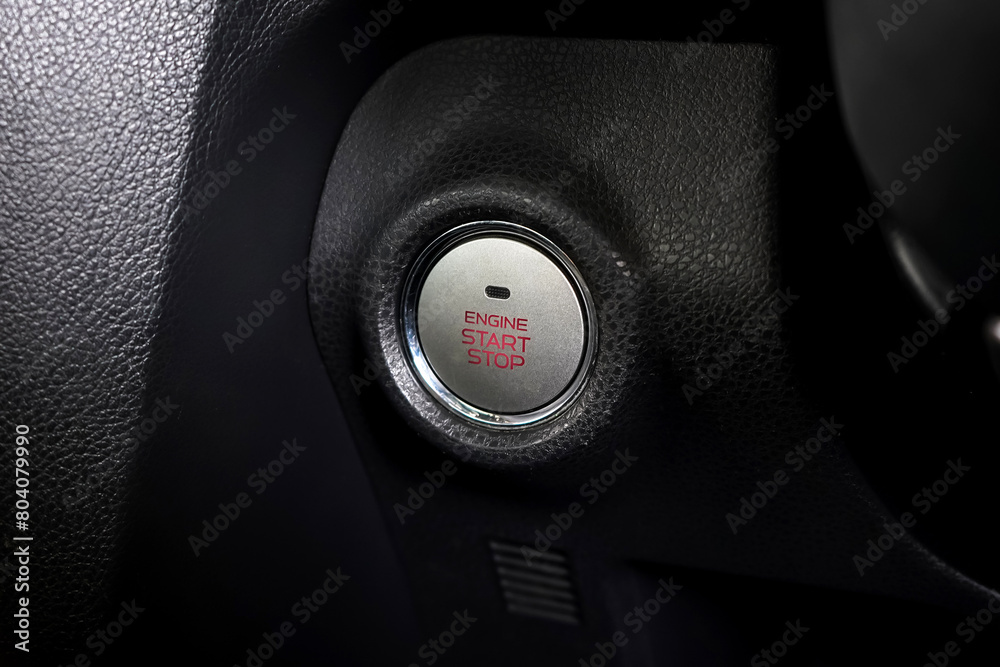 Close up engine car start button. Start stop engine modern new car button,Makes it easy to turn your auto mobile on and off. a key fob unique ,selective focus Close up engine car start button. Start stop engine modern new car button,Makes it easy to turn your auto mobile on and off. a key fob unique ,selective focus