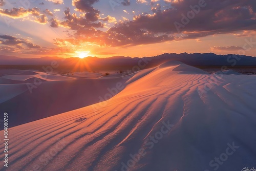 Fiery sunset over sand dunes with long shadows