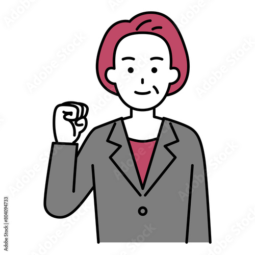 ガッツポーズをする年配のスーツの女性