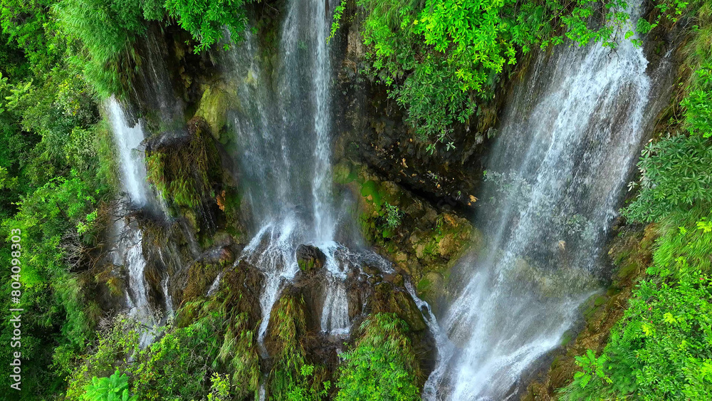 Obraz premium Venture deep into the untamed wilderness as your drone captures the breathtaking beauty of a triple waterfall nestled amidst a pristine tropical rainforest, a hidden treasure revealed. Thailand. 