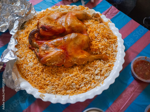 traditional yemen cuisine "mandi" with grilled chicken on the cooked basmati rice on the table in the restaurant