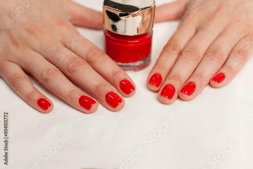 manicure on a white background and red nail polish