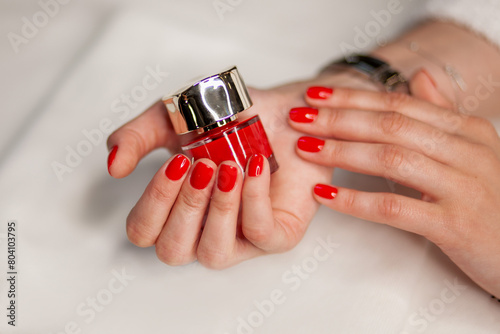 manicure on a white background and red nail polish