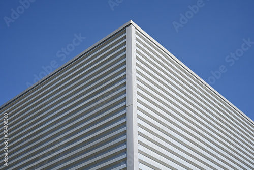 angle of an aluminum factory wall against blue sky