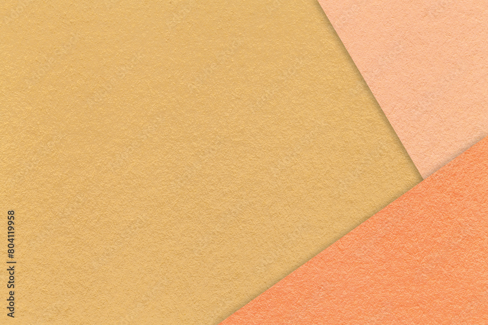 Texture of craft dark yellow paper background with peach and coral border. Vintage abstract ocher cardboard. Texture of craft dark yellow paper background with peach and coral border. Vintage abstract ocher cardboard.