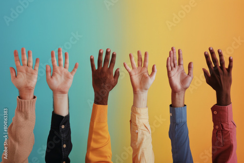 Inclusive concept featuring a row of raised hands with varying skin tones reaching up against a vibrant gradient backdrop, symbolizing unity, diversity, and collaboration photo