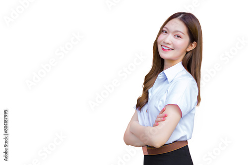 Portrait of an adult Thai student in university student uniform. Asian beautiful girl standing confidently with her arms crossed while isolated white background.