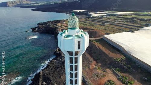 Aerial view of the Las Hoyas lighthouse and seeing the volcanic lava band of the Tajogaite volcano on the island of La Palma. photo