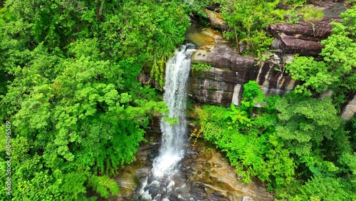 Aerial view of a lush tropical forest waterfall  captured by a drone  showcasing its breathtaking natural beauty. Soi Sawan Waterfall  Pha Taem National Park  Ubon Ratchathani Province  Thailand. 