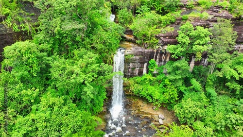Aerial view  Majestic waterfall cascades from lush tropical cliff  a breathtaking natural spectacle. Soi Sawan Waterfall  Pha Taem National Park  Ubon Ratchathani Province  Thailand. Nature concept. 