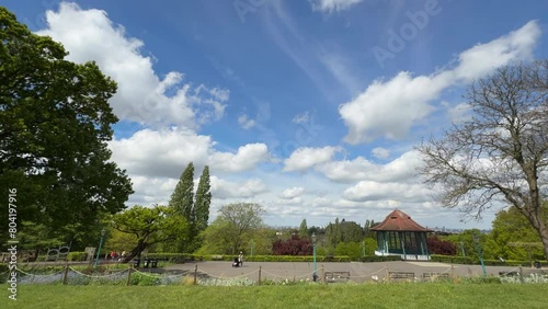 Horniman Gardens, Forest Hill, London, time lapse, blue sky, fast moving white clouds, band stand, slow pan left to right photo