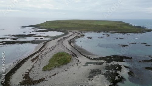 Drone shot flying over the tidal causeway linking Gunn Island, Strangford Lough, to County Down, Northern Ireland. photo