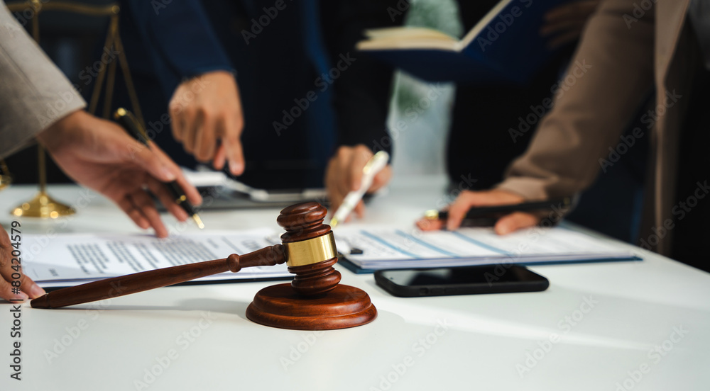 Business people and lawyers discussing contract papers sitting in the table at office in the morning. concepts of law, advice, legal services. Business people and lawyers discussing contract papers sitting in the table at office in the morning. concepts of law, advice, legal services.